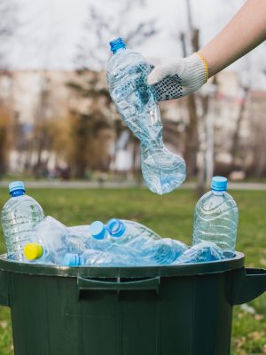 volunteer-putting-plastic-bottles-bin